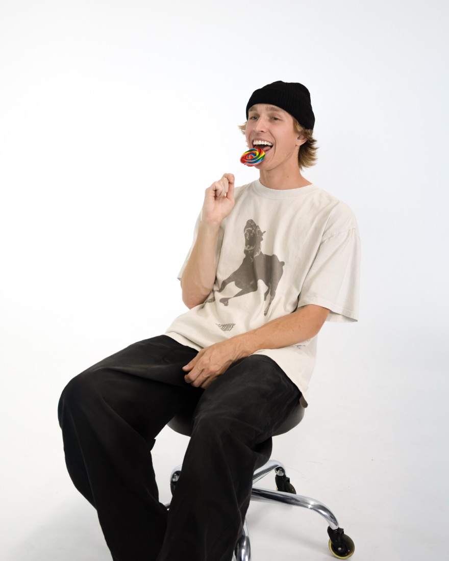 BBYFERG on a stool with a rainbow lollipop